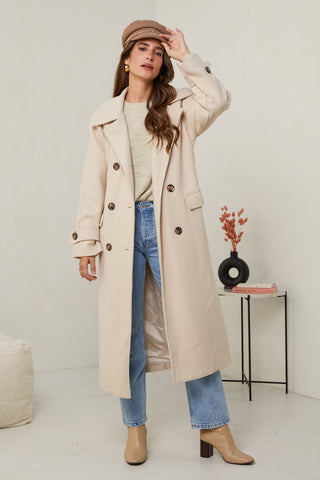 310 - Manteau long, col chemise, fermeture à six boutons avec un détaille boutons sur les poignets, une ceinture à la taille et deux poches à l'avant